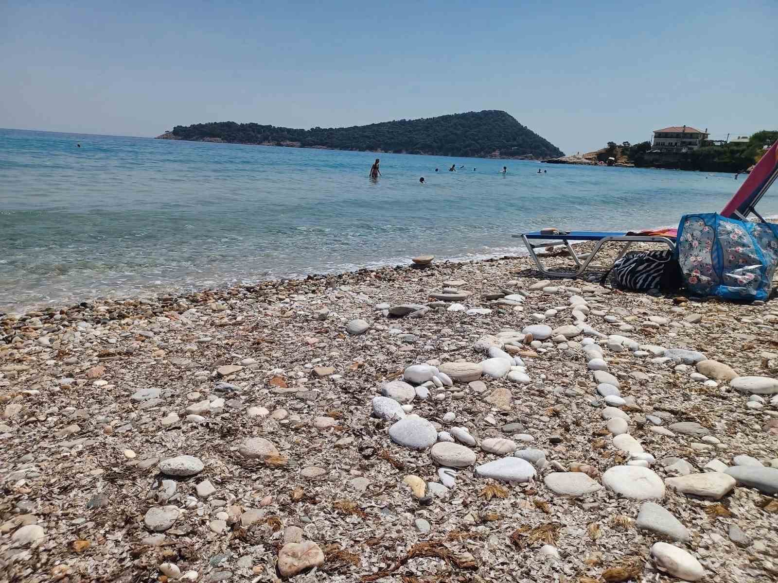 Swimmers at Kinira beach with the islet in the distance